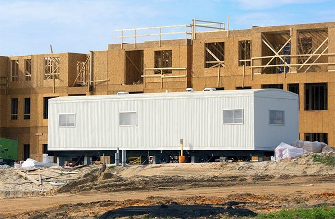 crane lifting modular building for construction office rentals in Montebello